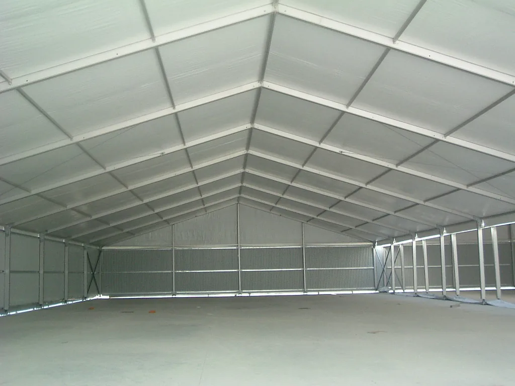 Interior of a large white warehouse tent with clear-span space